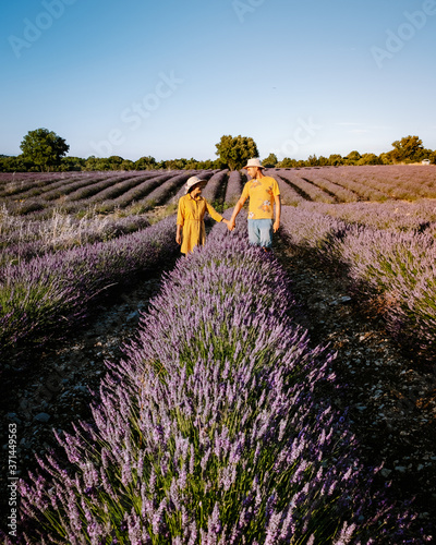 couple men and woman watching sunset in lavender fields in the south of France, Ardeche lavender fields iduring sunset, Lavender fields in Ardeche in southeast France.Europe photo