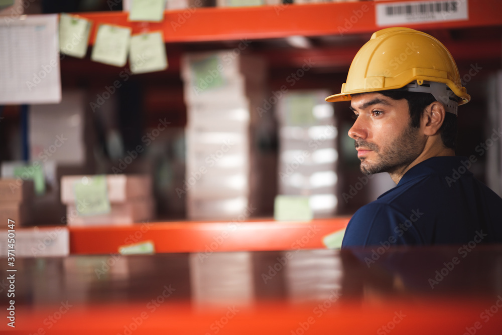 Male warehouse worker working for check and analyze newly arrived goods for further placement in storage department. Employee organizing goods distribution to the market Male warehouse worker working for check and analyze newly arrived goods for further placement in storage department. Employee organizing goods distribution to the market