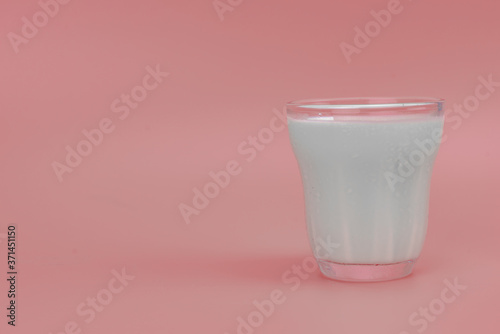 Fresh Milk in glass with copy space on pink background