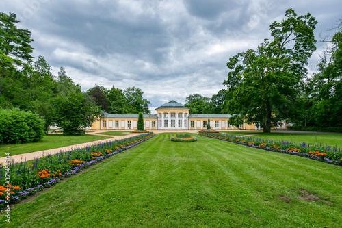 Wallpaper Mural Marianske Lazne / Czech Republic - July 12 2020: View of the Ferdinand pavilion standing in a park with trees, green lawn and colorful flowers on a summer day. Grey sky. Torontodigital.ca