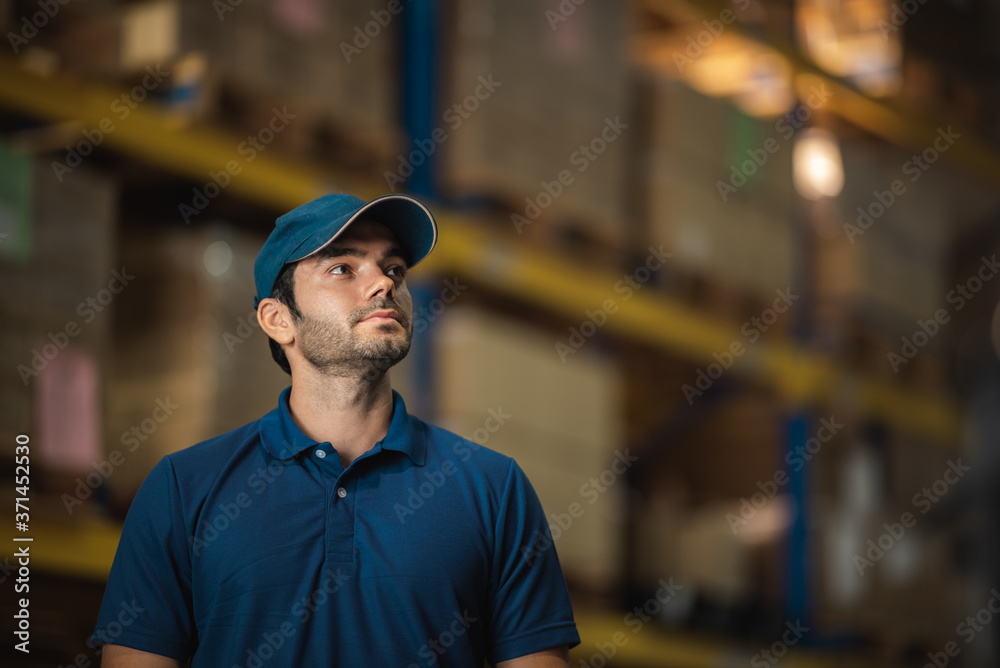 Male warehouse worker working for check and analyze newly arrived goods for further placement in storage department. Employee organizing goods distribution to the market Male warehouse worker working for check and analyze newly arrived goods for further placement in storage department. Employee organizing goods distribution to the market