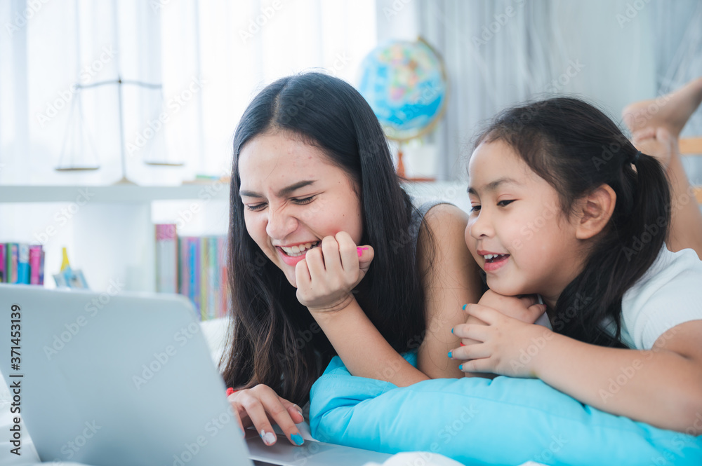 young women and girl using laptop for relaxing at home young women and girl using laptop for relaxing at home