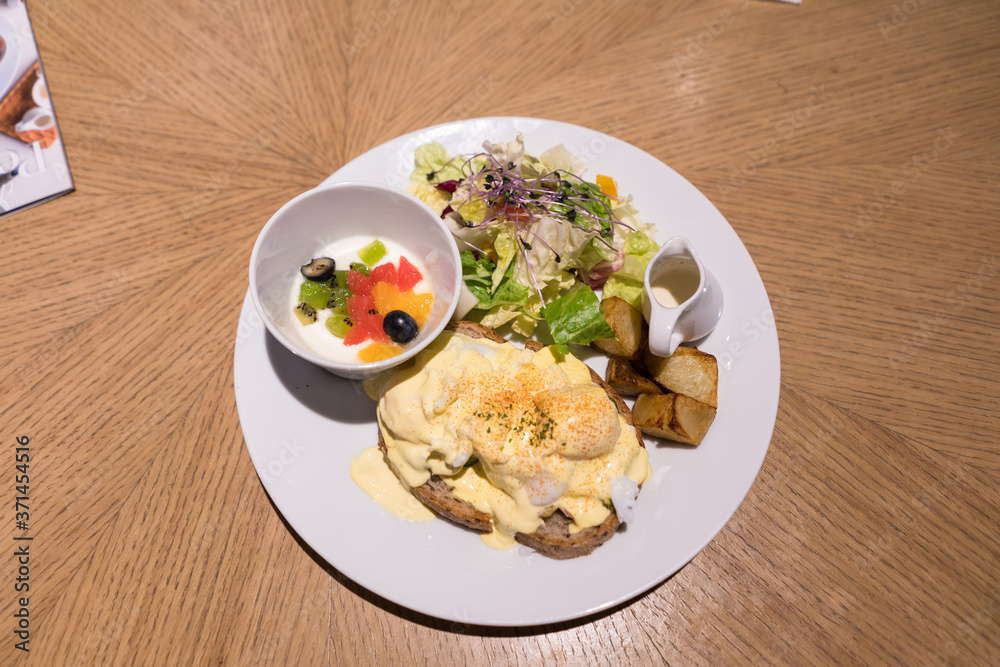 Substantial breakfast with fried egg, salad, bread and coffee, top view