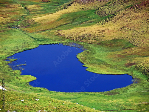 Nameless small alpine lakes and natural mini ponds on the mountain plateaus in the Uri Alps mountain massif, Kerns - Canton of Obwald, Switzerland (Kanton Obwalden, Schweiz) photo