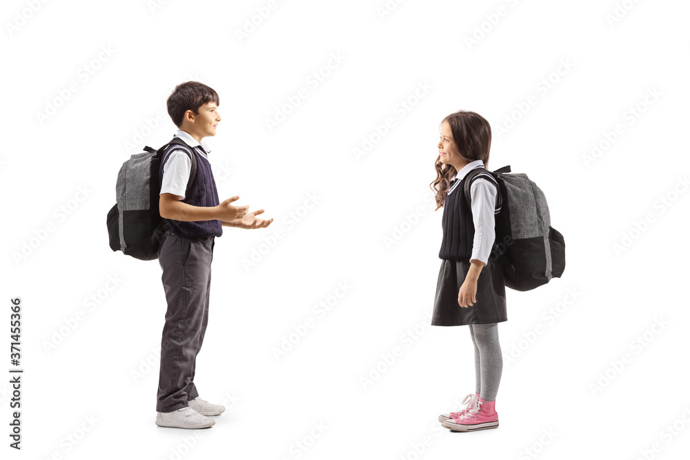 Full length profile shot of a schoolboy gesturing with hands and talking to a schoolgirl Full length profile shot of a schoolboy gesturing with hands and talking to a schoolgirl