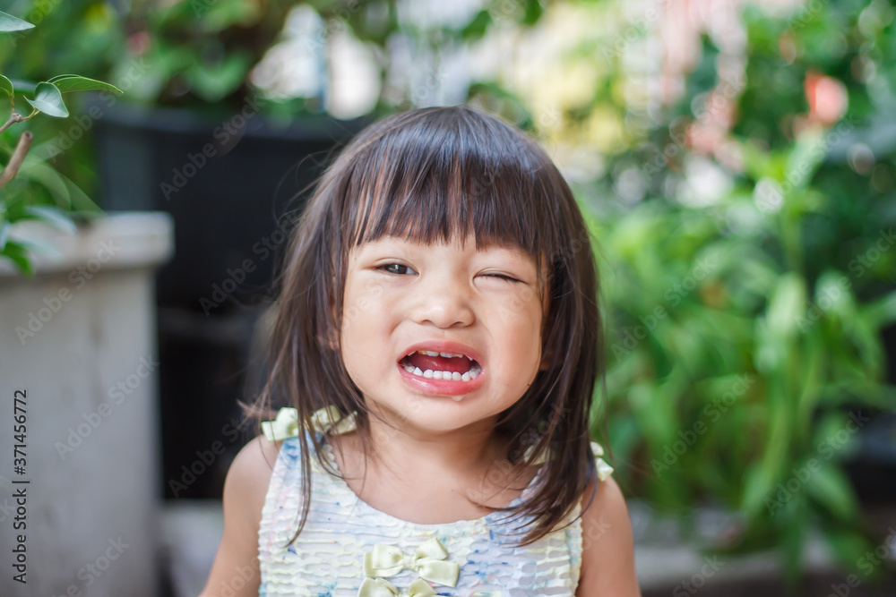 Portrait image of 2-3 years old baby girl. Asian child girl crying when she playing with the toy at the playground. Expression and emotions of baby concept. Portrait image of 2-3 years old baby girl. Asian child girl crying when she playing with the toy at the playground. Expression and emotions of baby concept.