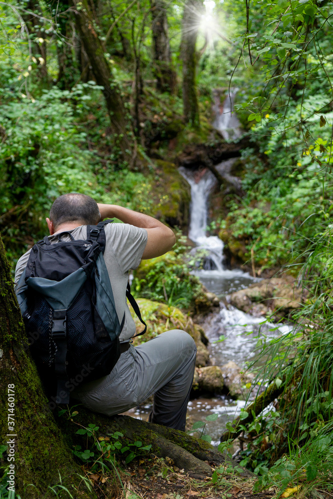 hiker photographing waterfall bard'natore in calabritto