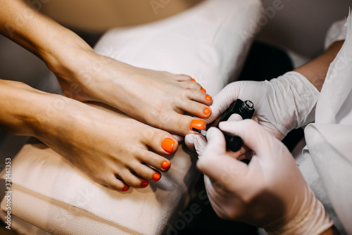 Woman at pedicure procedure with shellac at a beauty salon.