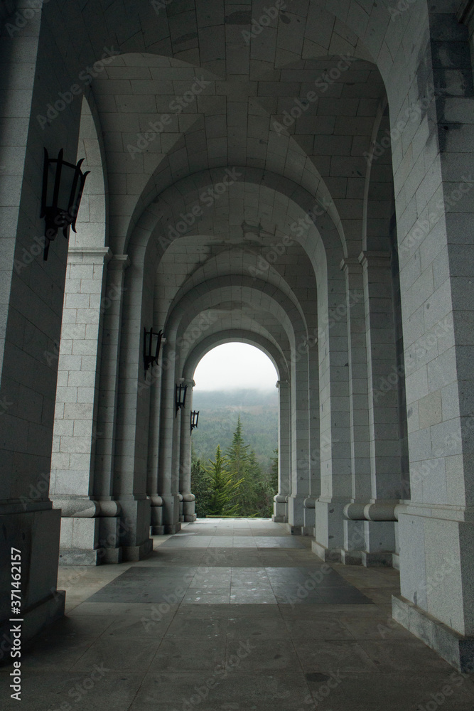 Fototapeta premium Architecture. Empty exterior corridor, concrete archway and columns in the closed Valley of the Fallen, Spain, due to coronavirus pandemic. 