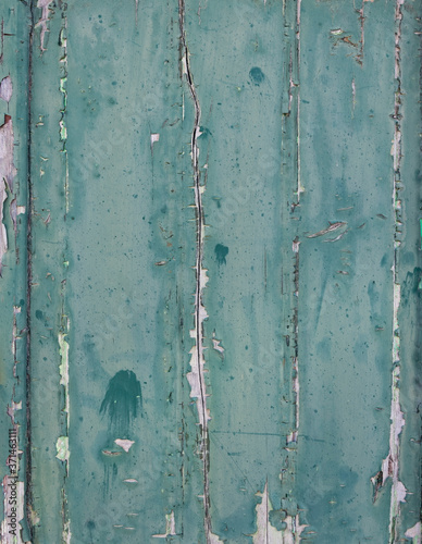 vertical planks with peeling blue green paint © ahavelaar
