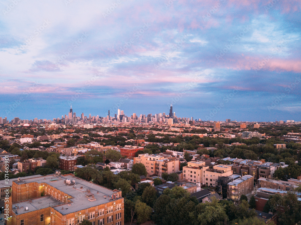 Aerial View of the Chicago City Skyline over the Urban Neighborhoods During Sunset
