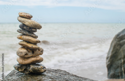 Stack of round smooth stones on a seashore