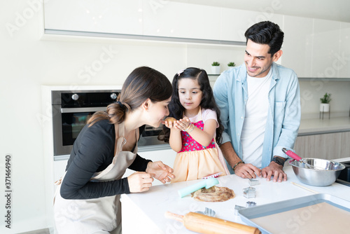 Girl Preparing Cookies With Family At Home