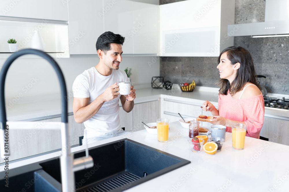 Couple Having Breakfast In Kitchen At Home Couple Having Breakfast In Kitchen At Home