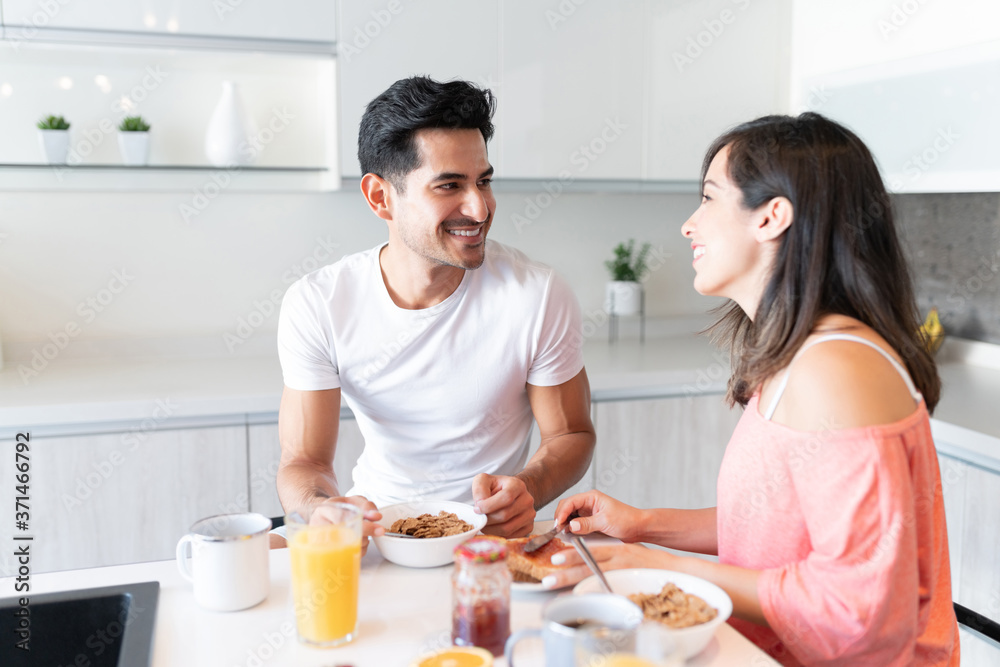 Happy Latin Couple Eating Breakfast At Home