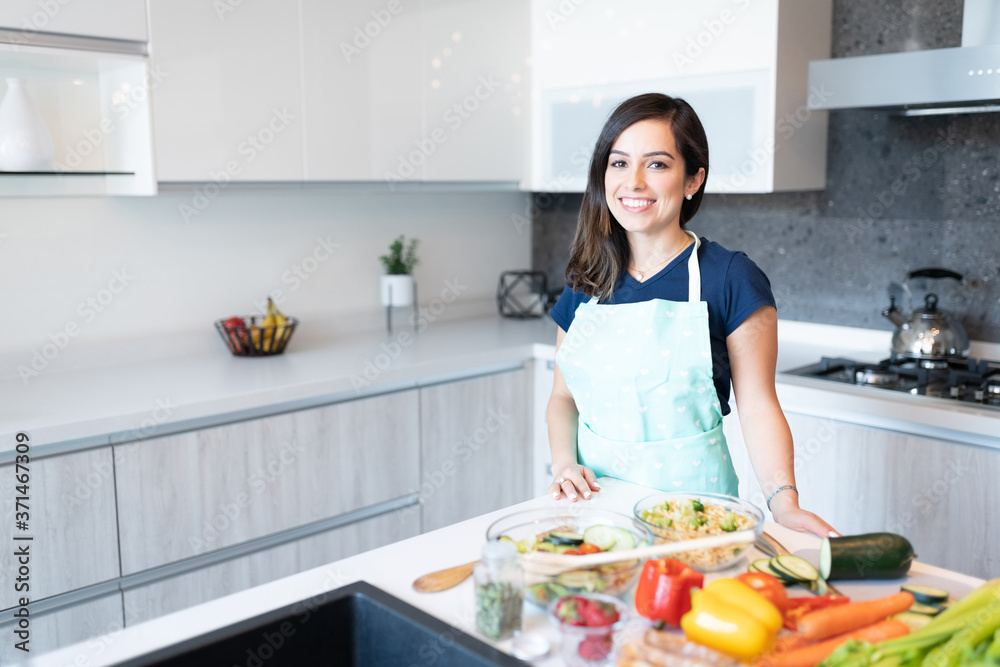 Hispanic Woman Preparing Food In Kitchen
