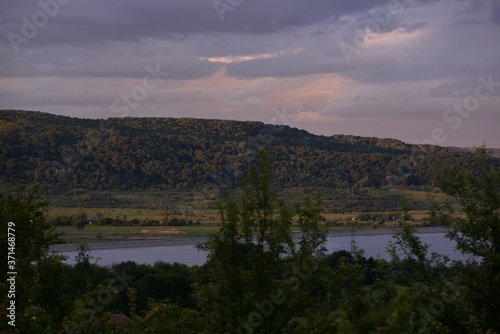 Fototapeta Naklejka Na Ścianę i Meble -  spring landscape with forest near the lake at sunset. cultivated fields