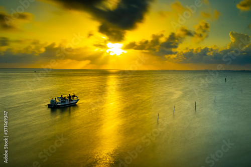 sunset sunrise on the ocean fish boat