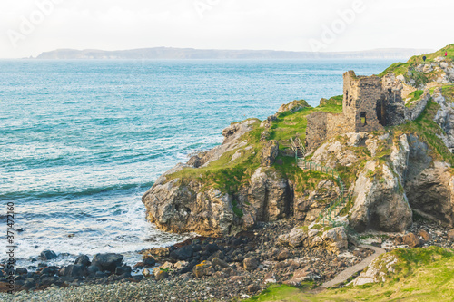 kinbane castle ruins in northern ireland coast with calm blue sea in background