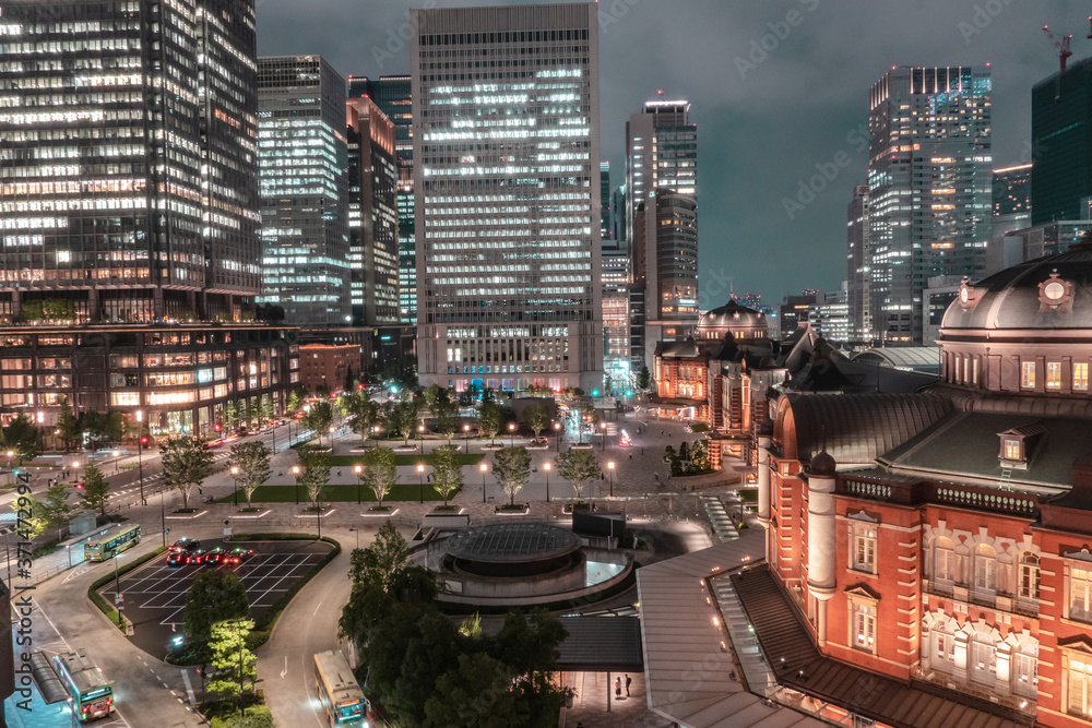 Beautiful urban cityscape with Tokyo station under twilight sky and neon night in Marunouchi business district, Japan