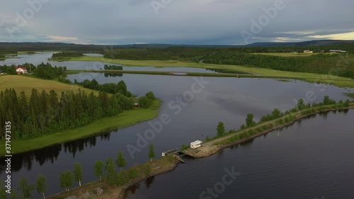 Aerial view of an RV parked on a land tongue in northern Sweden photo