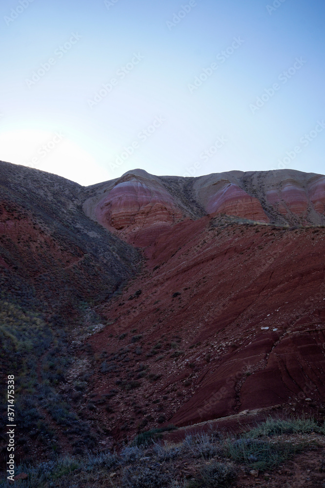 red sandstone outcrops on the slopes of Big Bogdo sacred mountain in Caspian steppe Bogdo-Baskunchak nature reserve, Astrakhan region, Russia. The highest point of the Caspian sea.