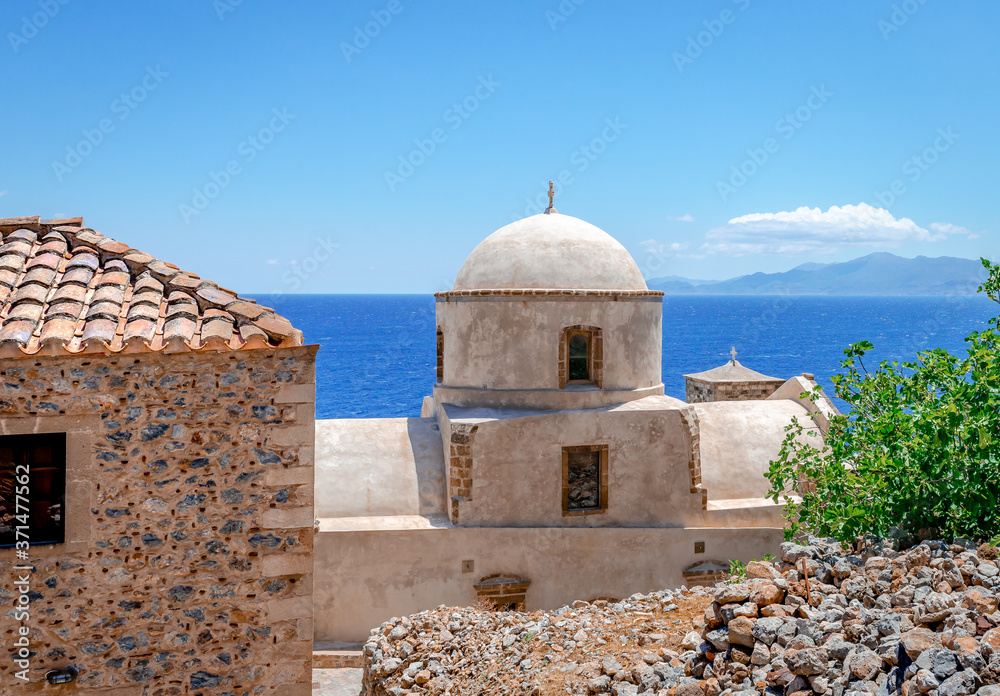View to the Aegean Sea from the medieval town of Monemvasia, with a white byzantine church in the forground. Peloponnese, Greece. View to the Aegean Sea from the medieval town of Monemvasia, with a white byzantine church in the forground. Peloponnese, Greece.