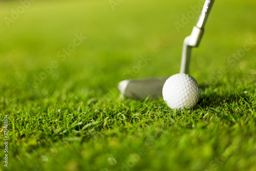 Golf ball on green grass ready to be struck
