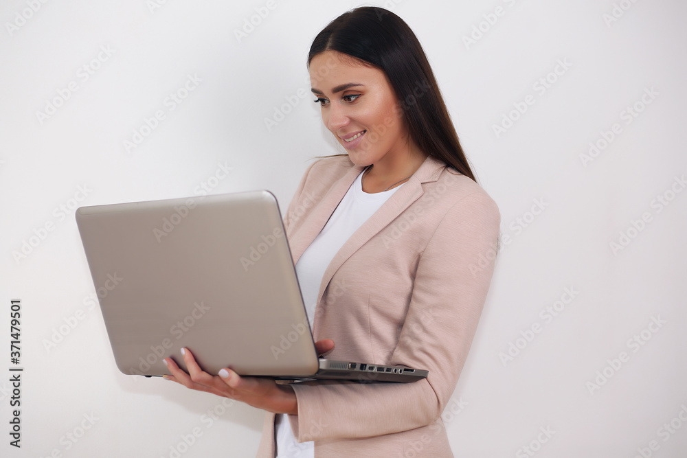 Attractive smiling young girl working on laptop computer Attractive smiling young girl working on laptop computer