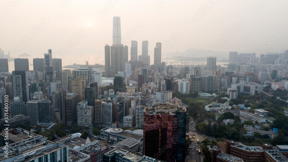 Hong Kong / March 28 2018: Aerial view of Hong Kong cityscape. Skyscrapers high glass buildings business centers roads car traffic daily city life. Concrete jungle. Megalopolis. Smog gray cloudy sky