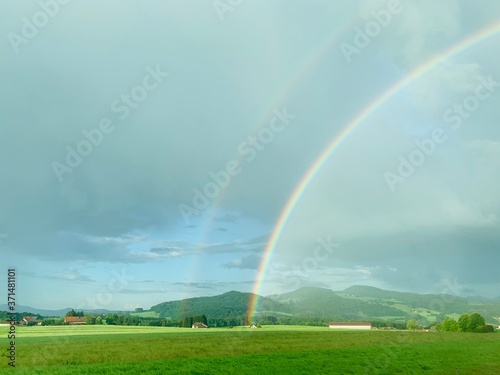rainbow over green fields