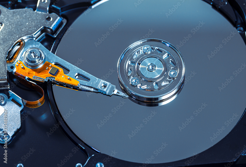 Disassembled hard drive from the computer, hdd with mirror effect. Opened hard drive from the computer hdd with mirror effects. Part of computer pc, laptop.