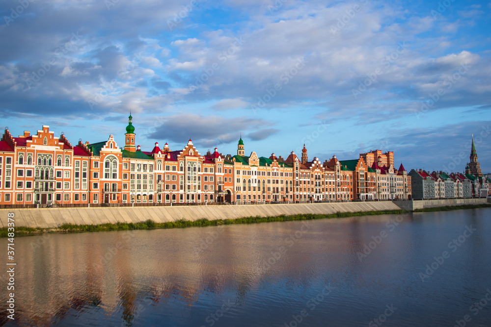 Naklejka premium architecture of houses with reflection in the water on Brugge Embankment in Yoshkar-Ola, Russia