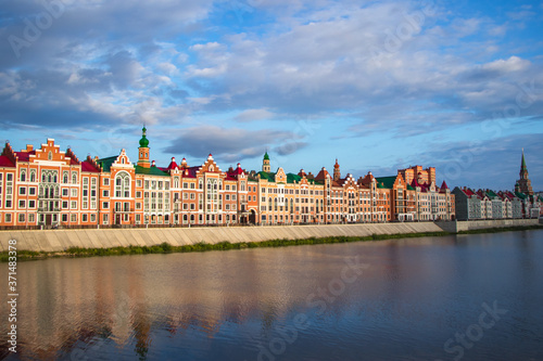 architecture of houses with reflection in the water on Brugge Embankment in Yoshkar-Ola, Russia