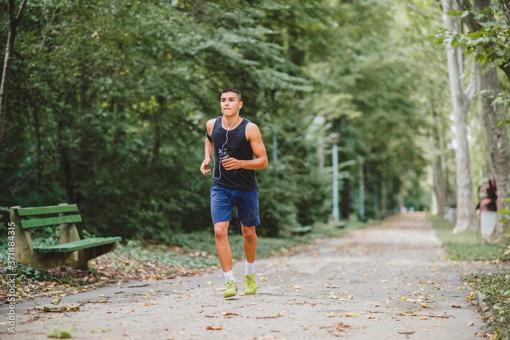 Young Caucasian man jogging in the park