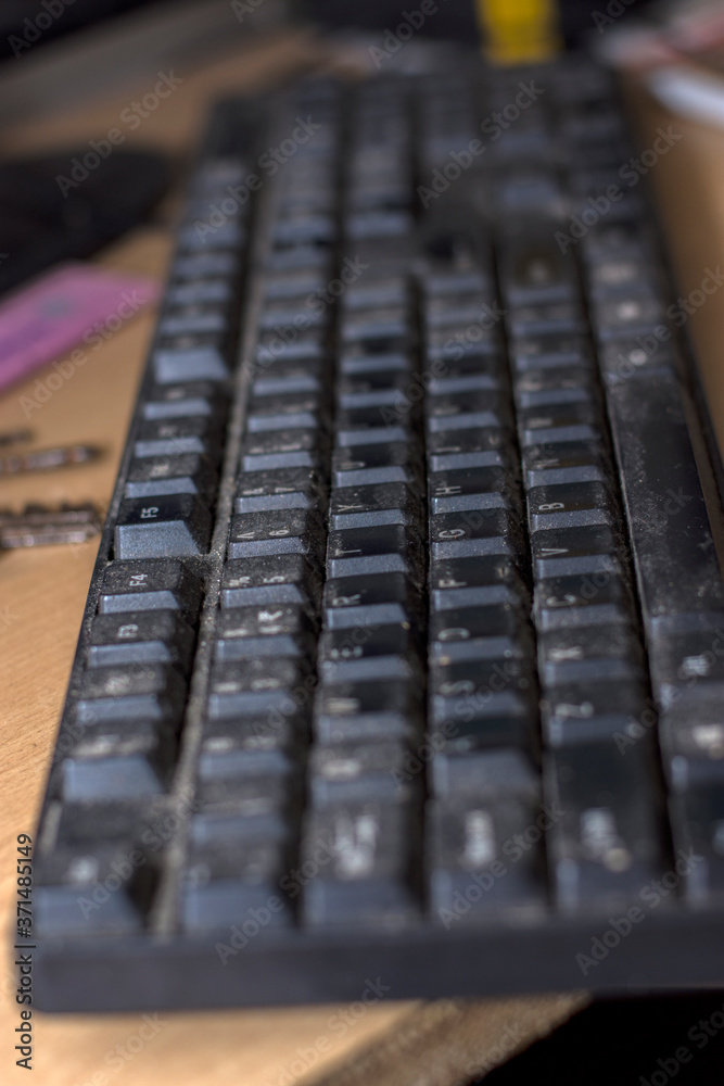 A old useful black keyboard with full of dust