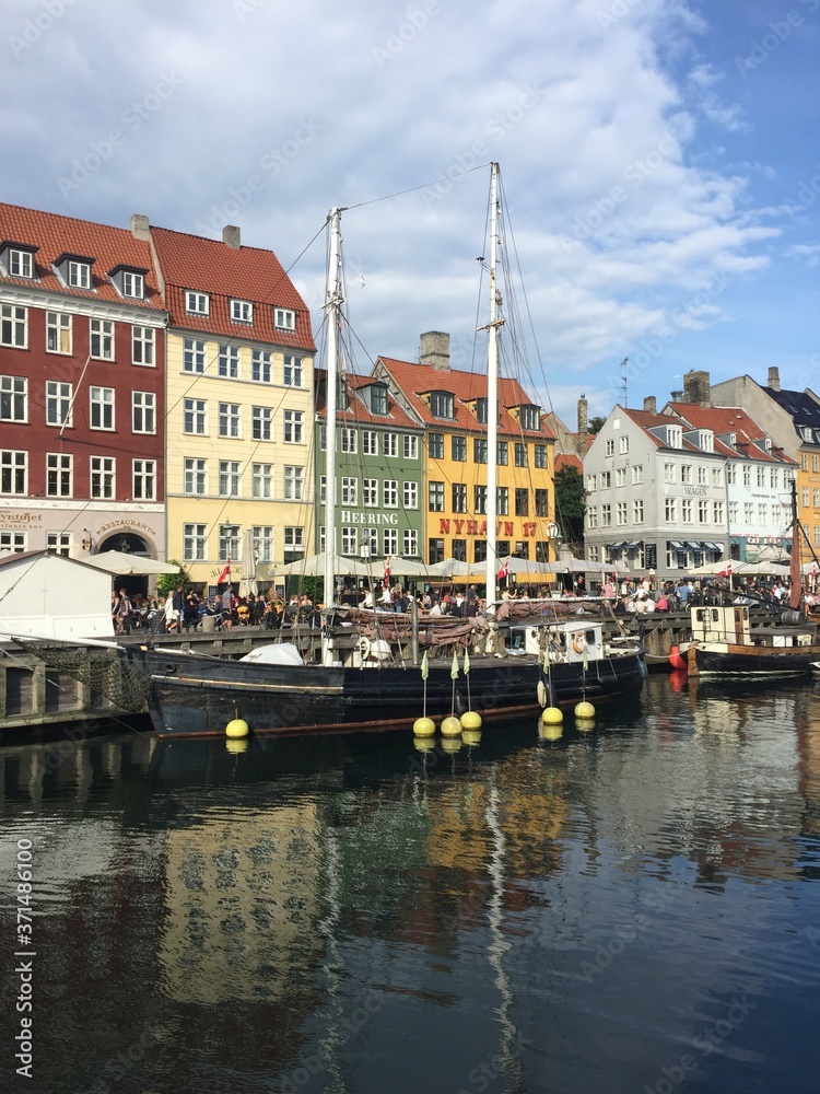 View of Nyhavn pier with colorful buildings and boats in the Old Town of Copenhagen. Denmark
