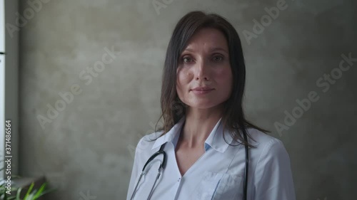 Wallpaper Mural Brunette female medic in a white coat with a phonendoscope Torontodigital.ca