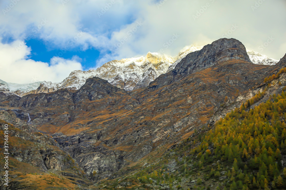 View of alp mountain in autumn have snow on top hill