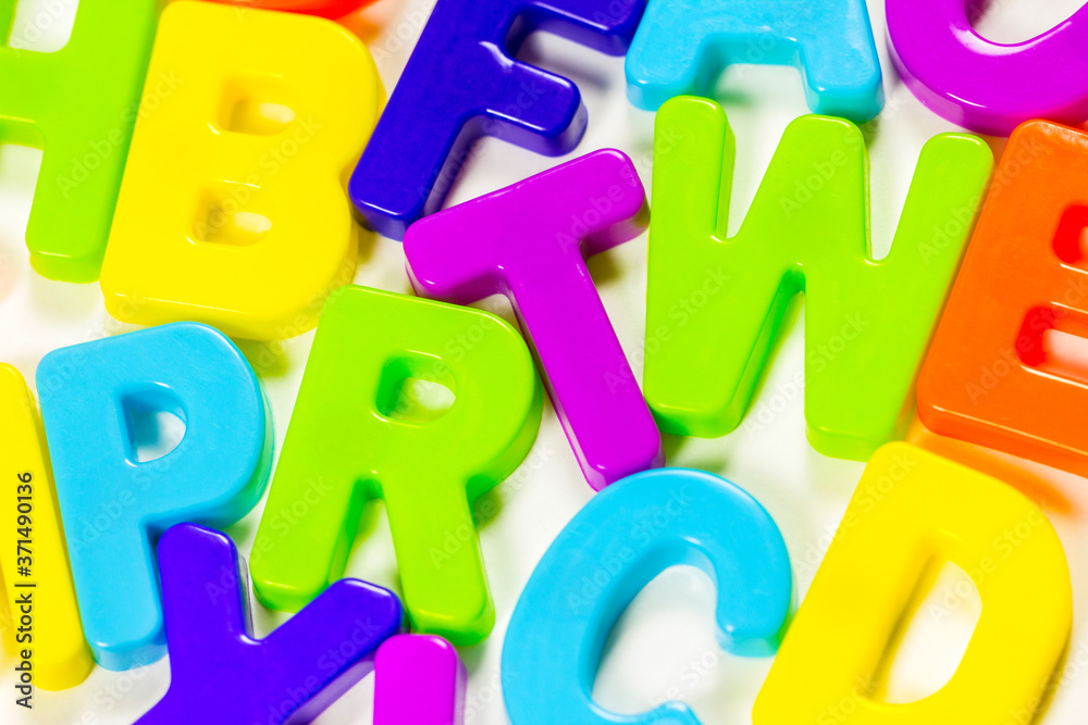The concept of going back to school. Multi-colored three-dimensional Latin letters on a white background. The view from the top The concept of going back to school. Multi-colored three-dimensional Latin letters on a white background. The view from the top