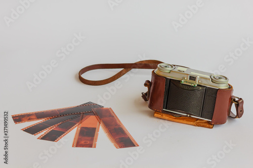 old camera with negative / Old vintage camera used by photographers with the negatives consist of frames from which develops  the picture