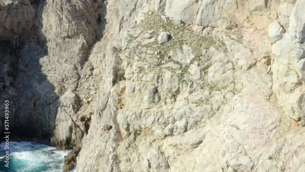 AERIAL: Edge of Cliff with Blue Water Waves crushing on Tropical Island Mallorca, Spain Vacation, Travel, Sunny, Waves AERIAL: Edge of Cliff with Blue Water Waves crushing on Tropical Island Mallorca, Spain Vacation, Travel, Sunny, Waves