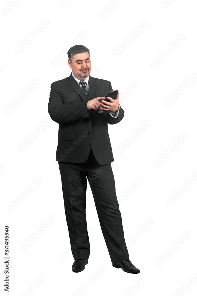 A man in a suit looks at messages on a tablet and smiles A man in a suit looks at messages on a tablet and smiles