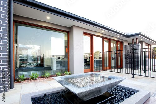 Backyard of luxury house with big glass door and windows