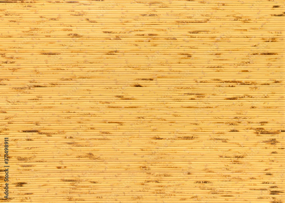 background and texture of decorative yellow bamboo wood on finishing wall surface. bamboo line making from fire burn. background and texture of decorative yellow bamboo wood on finishing wall surface. bamboo line making from fire burn.