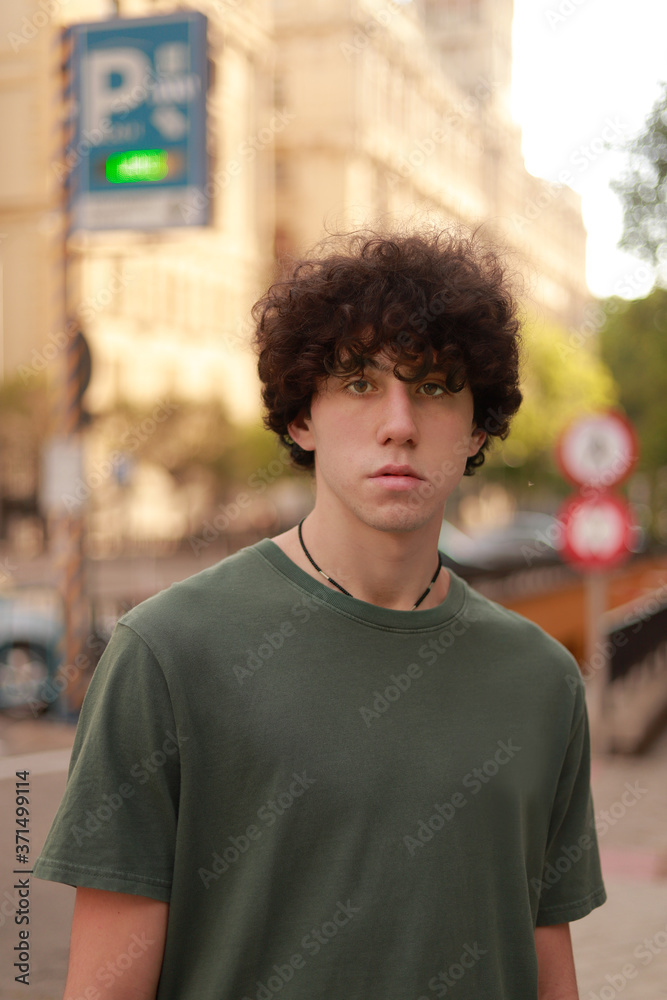 caucasian boy with afro looking at the camera outdoors caucasian boy with afro looking at the camera outdoors