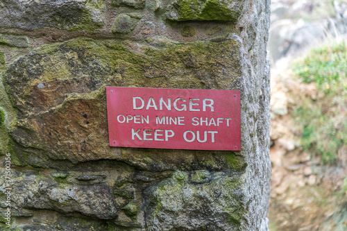 Danger Open Mine Shaft Keep Out sign on an old tin mine in Cornwall