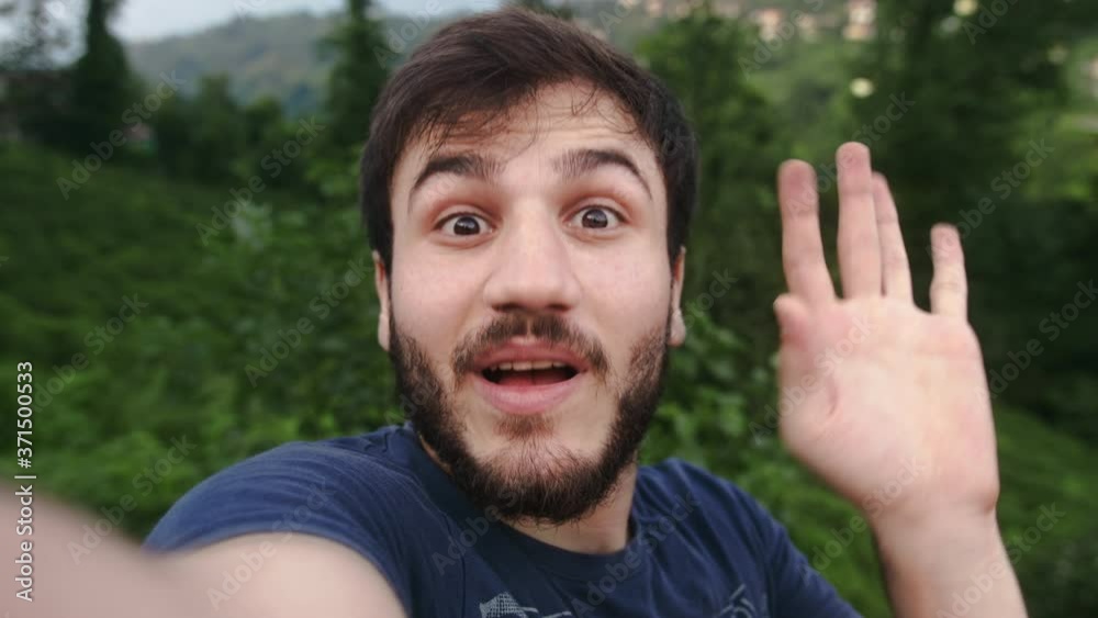 Handsome young man making video call on phone in nature 4K Lifestyle concept Handsome young man making video call on phone in nature 4K Lifestyle concept