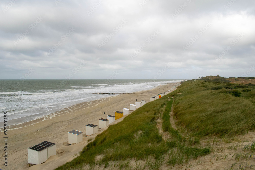 Sand dunes at the beach with clouds on the Dutch coast