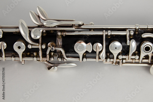 Old oboe on a gray background. Musical instrument